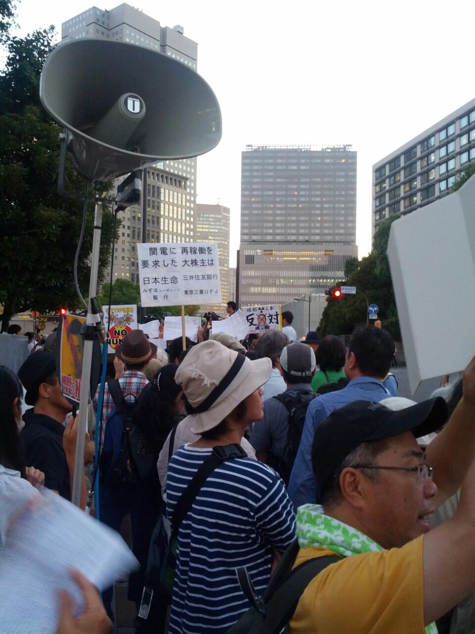 protesters are standing with their laptops in the middle of an urban street