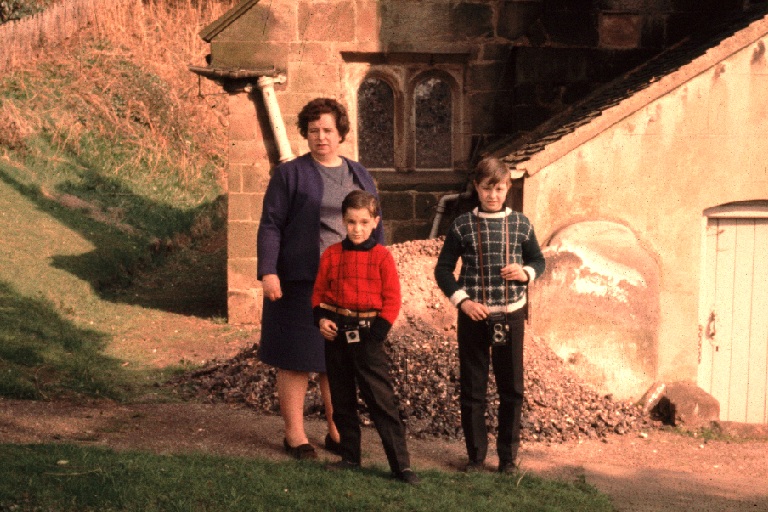a family of three in the back of a castle