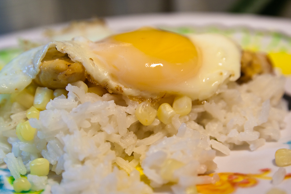 rice and fried egg is sitting on a plate