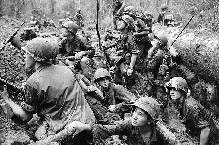 a bunch of soldiers kneeling in the mud together