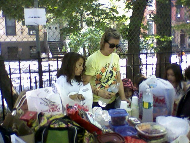 a man is standing with two girls at a table