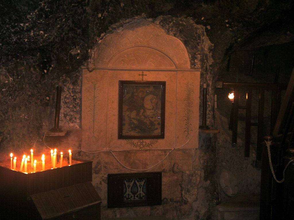 candles in the church lite in bright orange flames