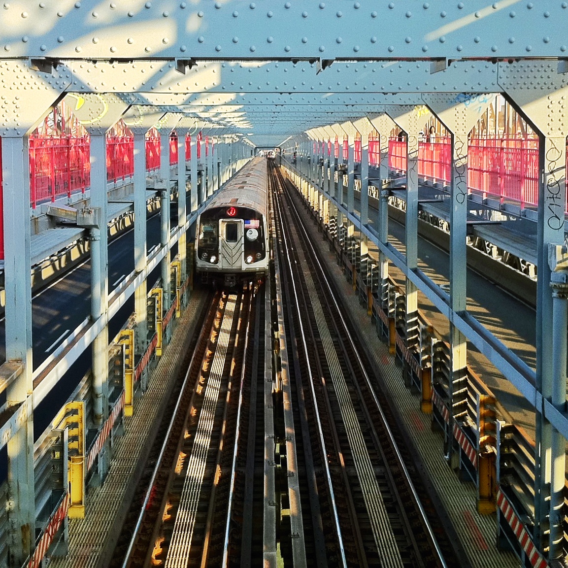 train tracks running parallel to each other with trains pulling in at the end