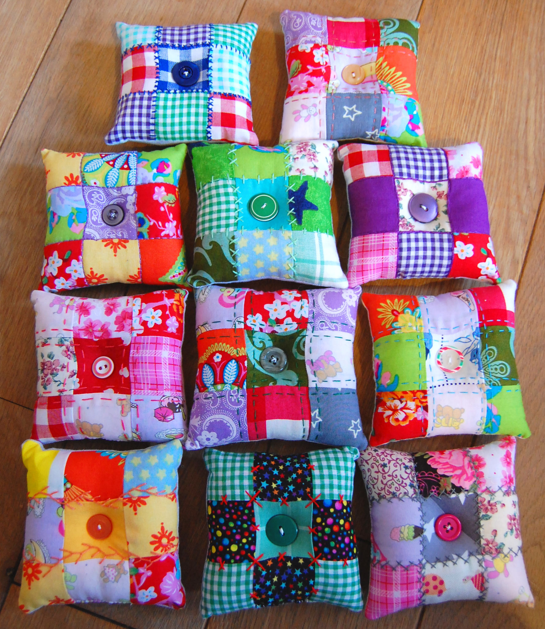 a colorful square shaped pillow is made of small patchwork