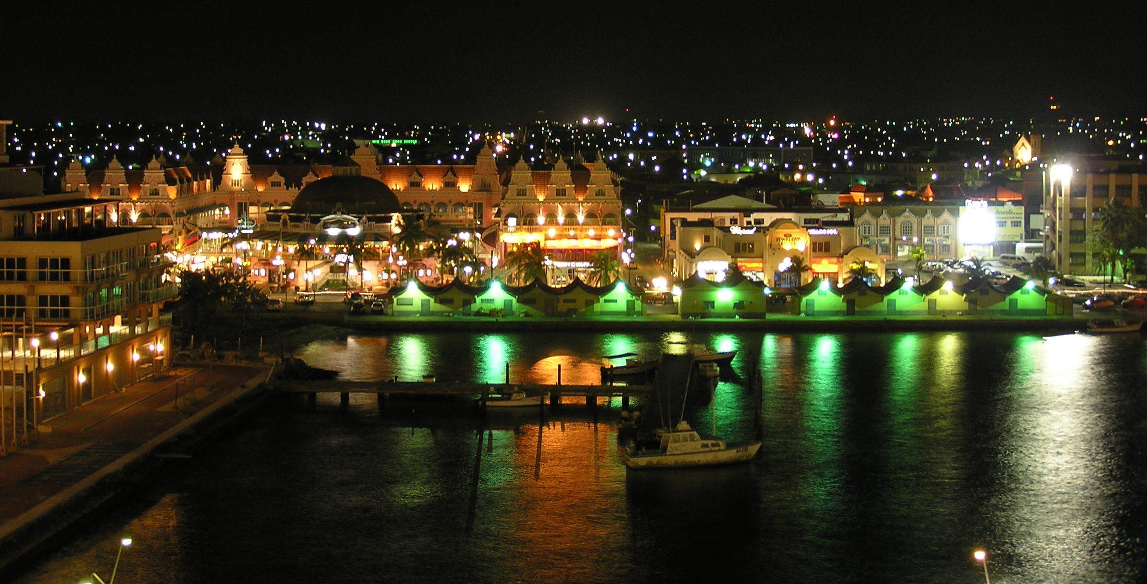 a cityscape with lots of lights around the water