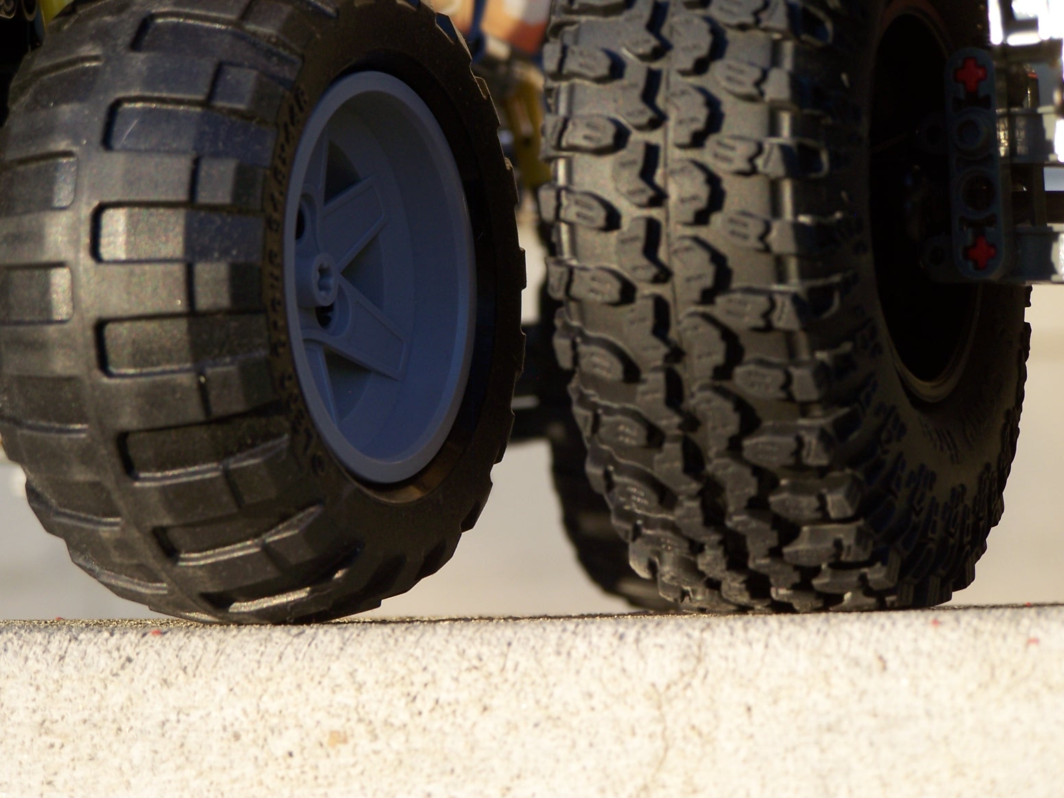 two trucks are shown one is black and the other is blue