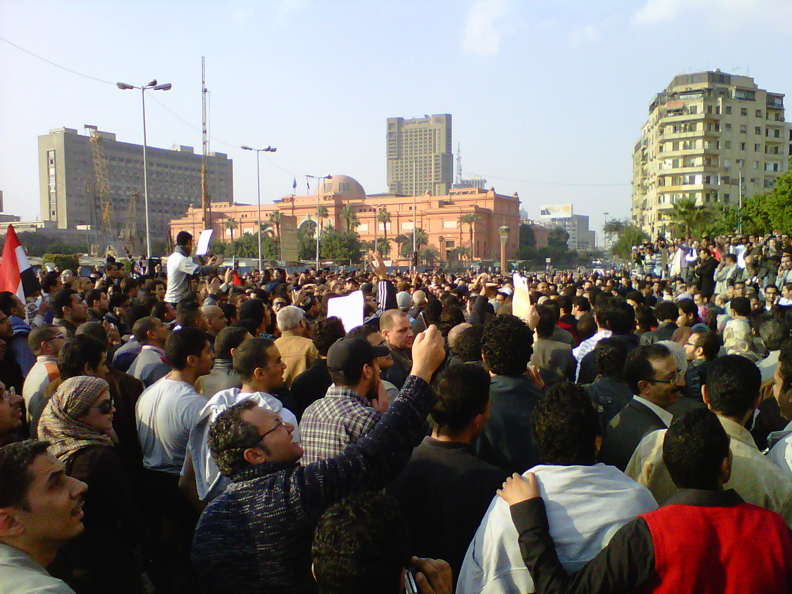 an outdoor gathering in the city in front of a building