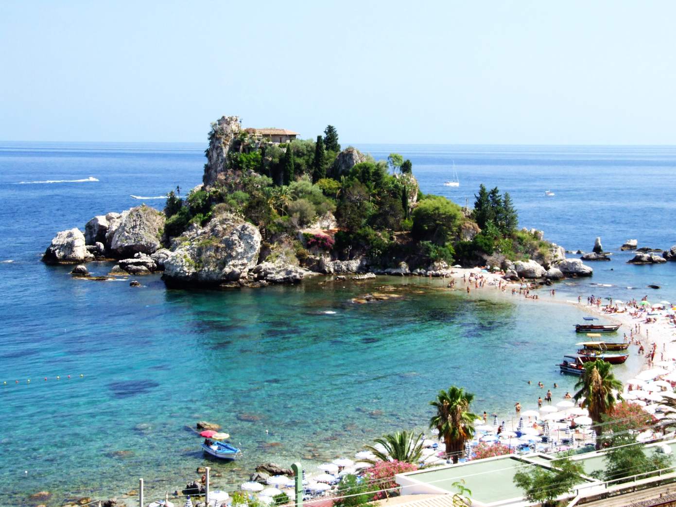 an aerial view of the clear blue waters and beautiful shoreline