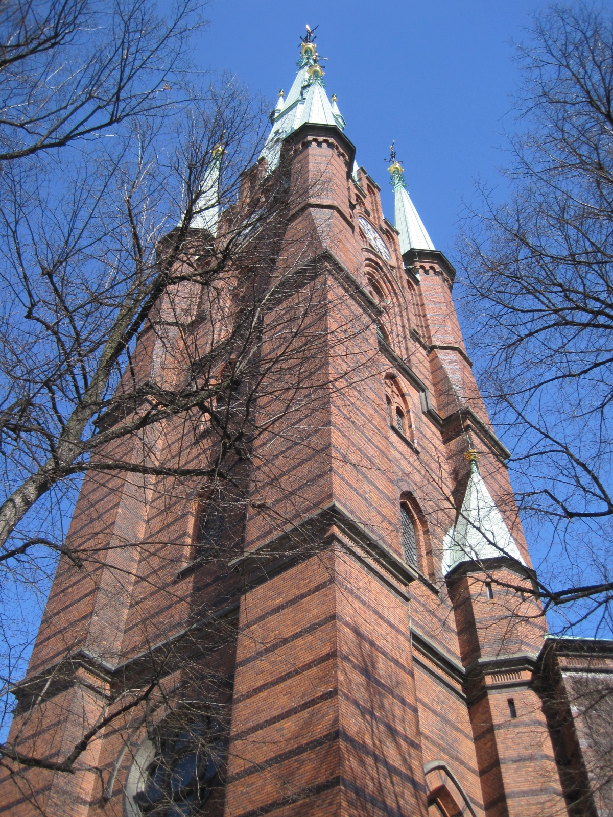 there is an old brick church tower that has steeple