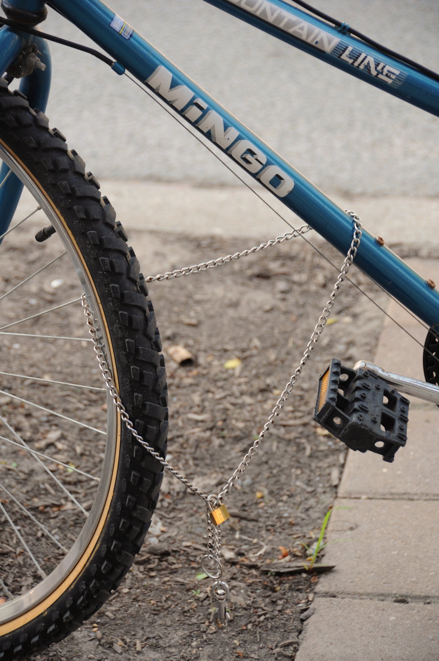 the chain of a blue bike is shown attached to it's seat