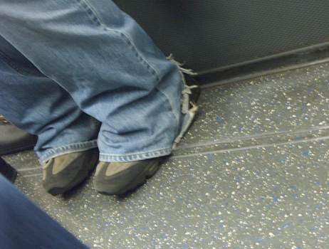 a person wearing boots sitting on a subway