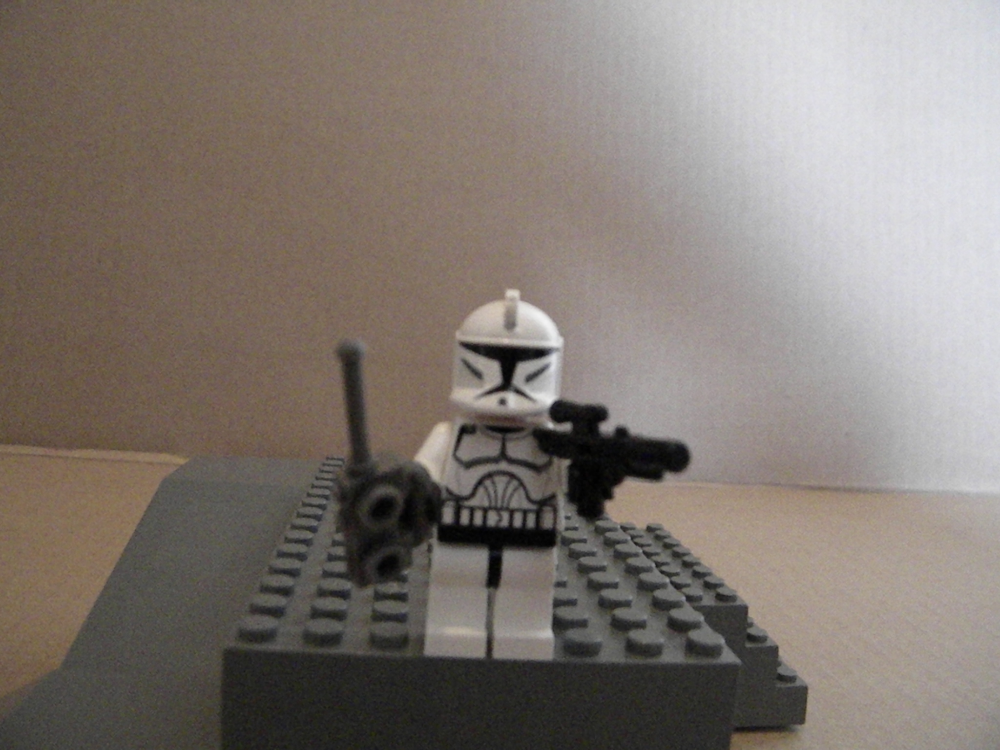 an lego storm trooper is holding a weapon