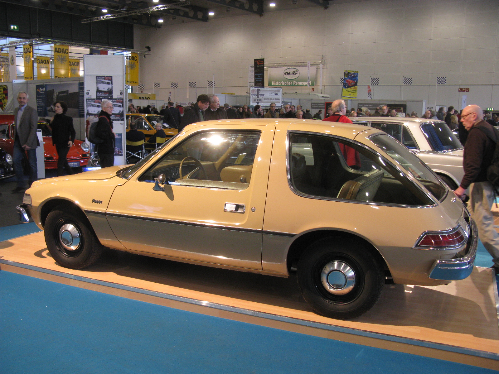 two old car are on display at a show