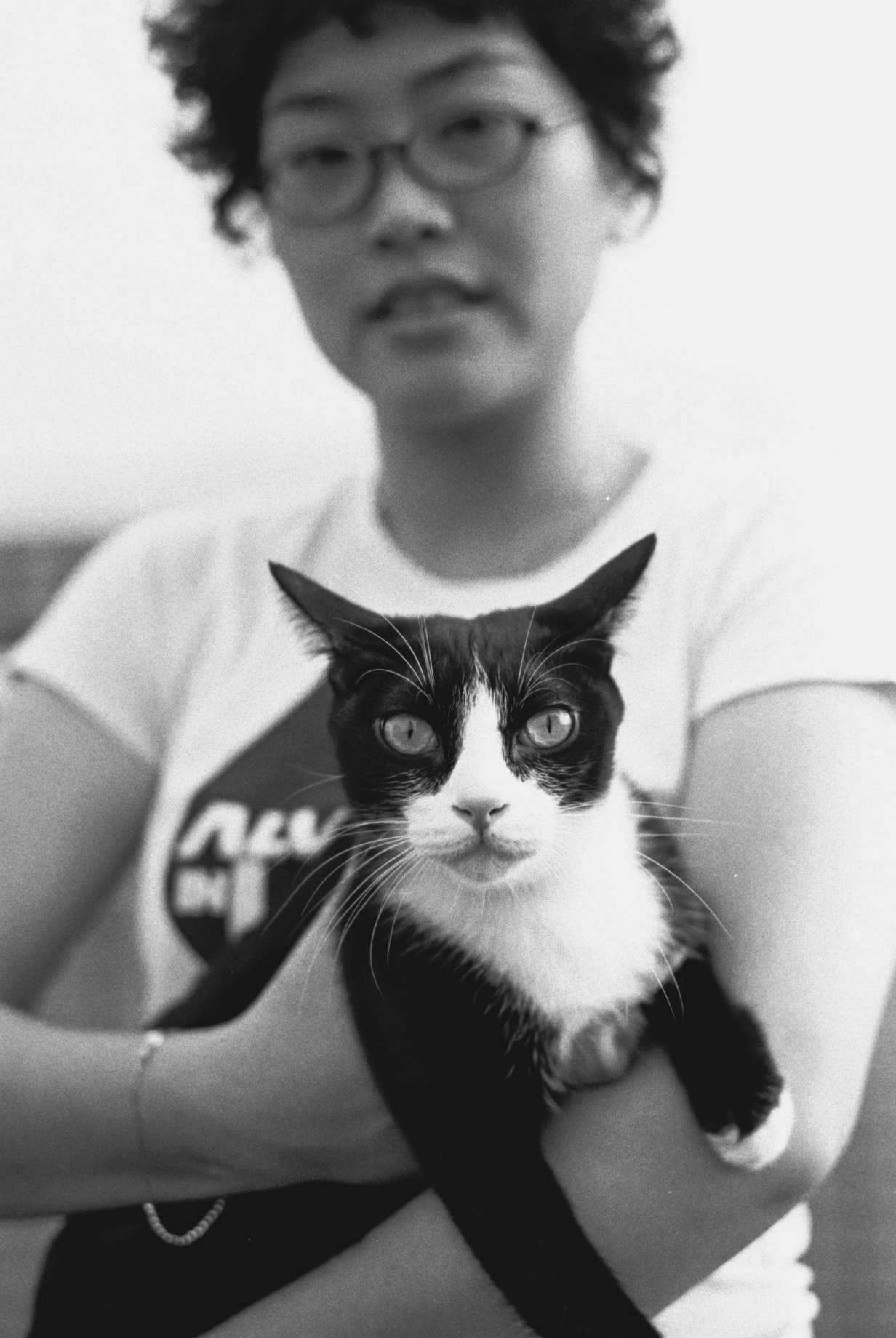 a woman holds a cat on her arm