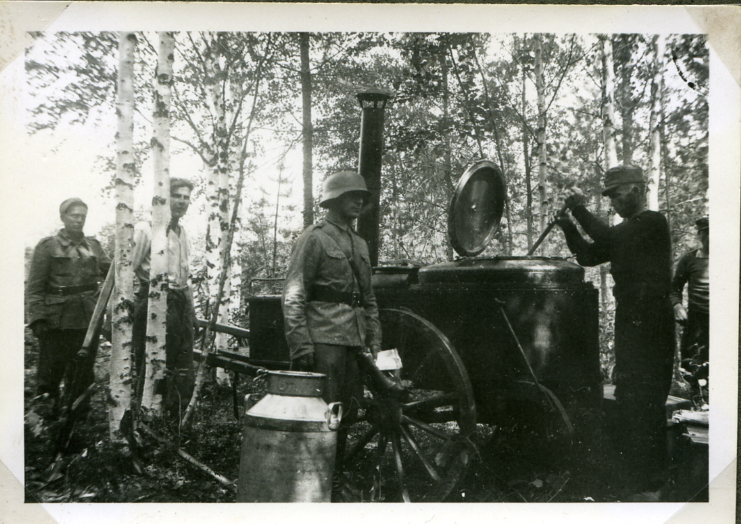 an old black and white po of men working on a machine