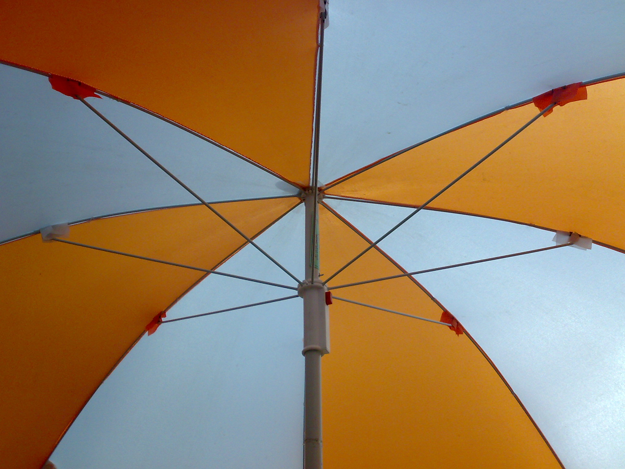 an orange and blue umbrella has the handle extended