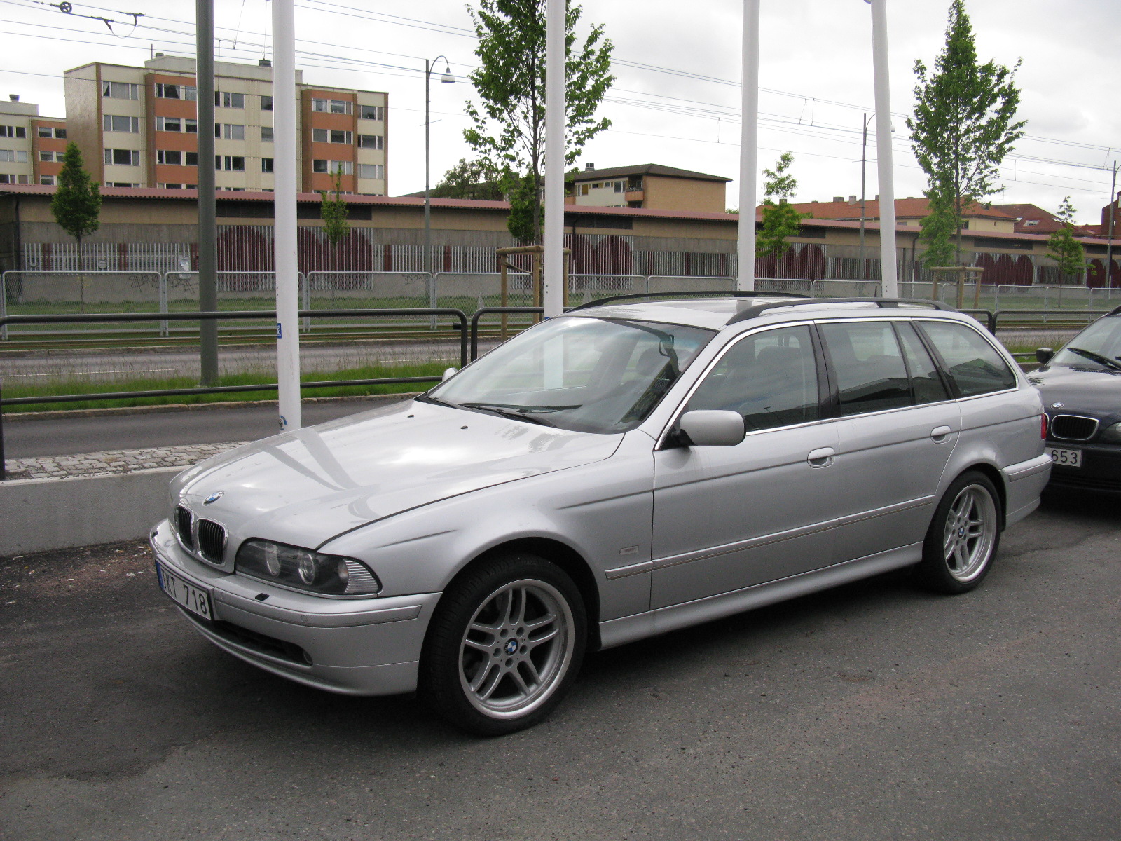 an silver car is sitting on the side of the road