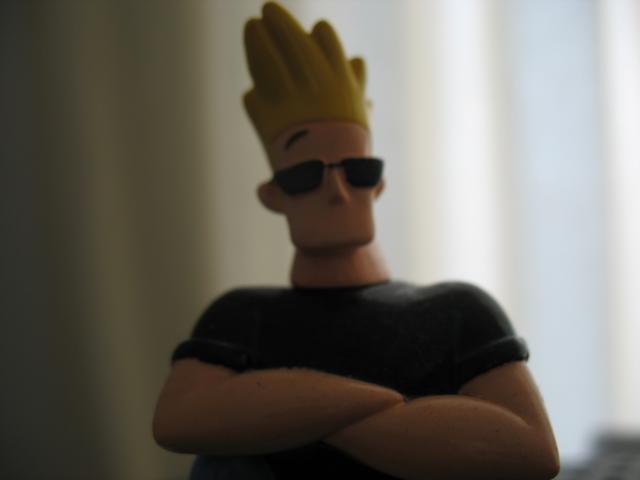 a toy figure wearing sunglasses and a crown