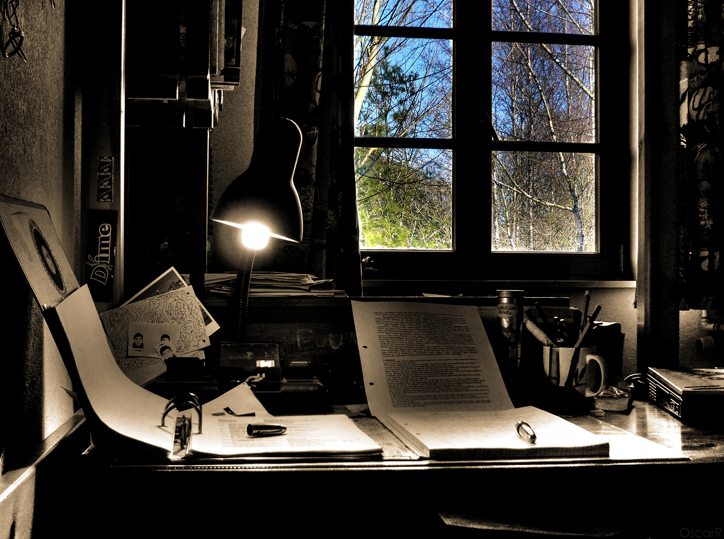 a desk with an open book and a lamp next to it