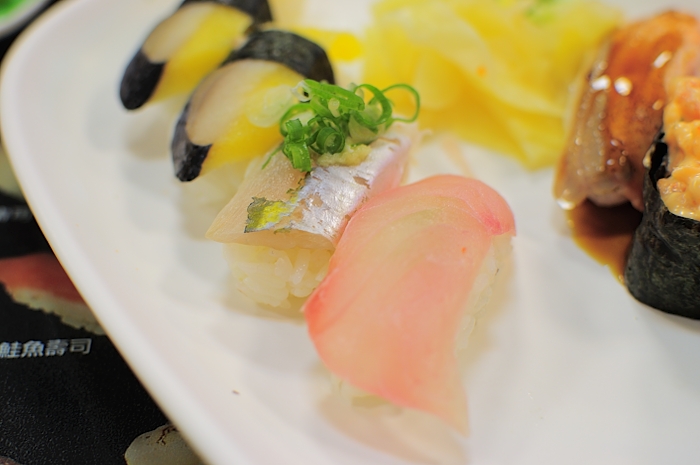 several different sushi on a white plate