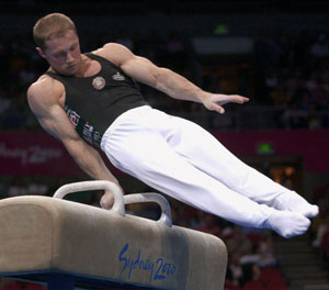 a man on a gymnastics beam jumping