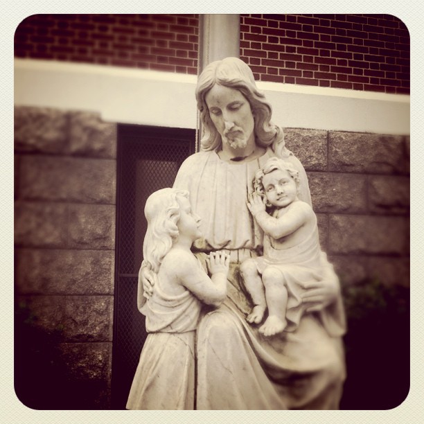 a statue of jesus with baby jesus in a corner