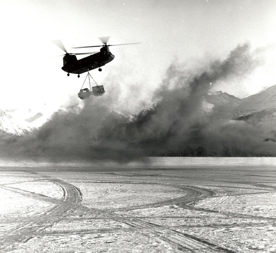 a helicopter flying above an icy lake on skis