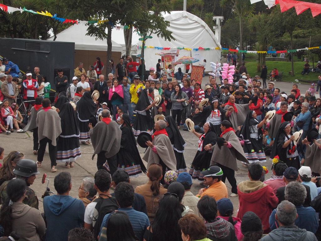 a crowd of people are dressed in native costumes