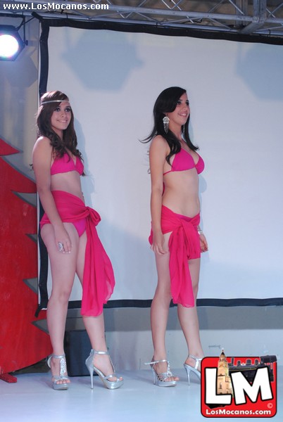 two ladies in pink dresses standing next to each other