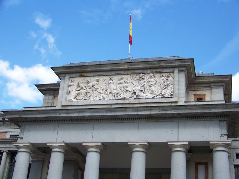 the facade of an art museum with columns and a flag