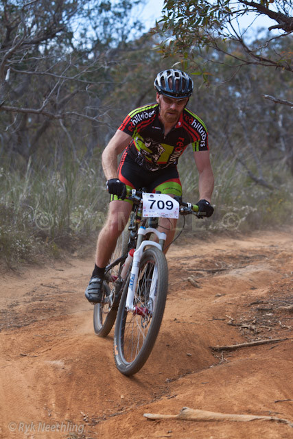 an athlete rides his bicycle down the path
