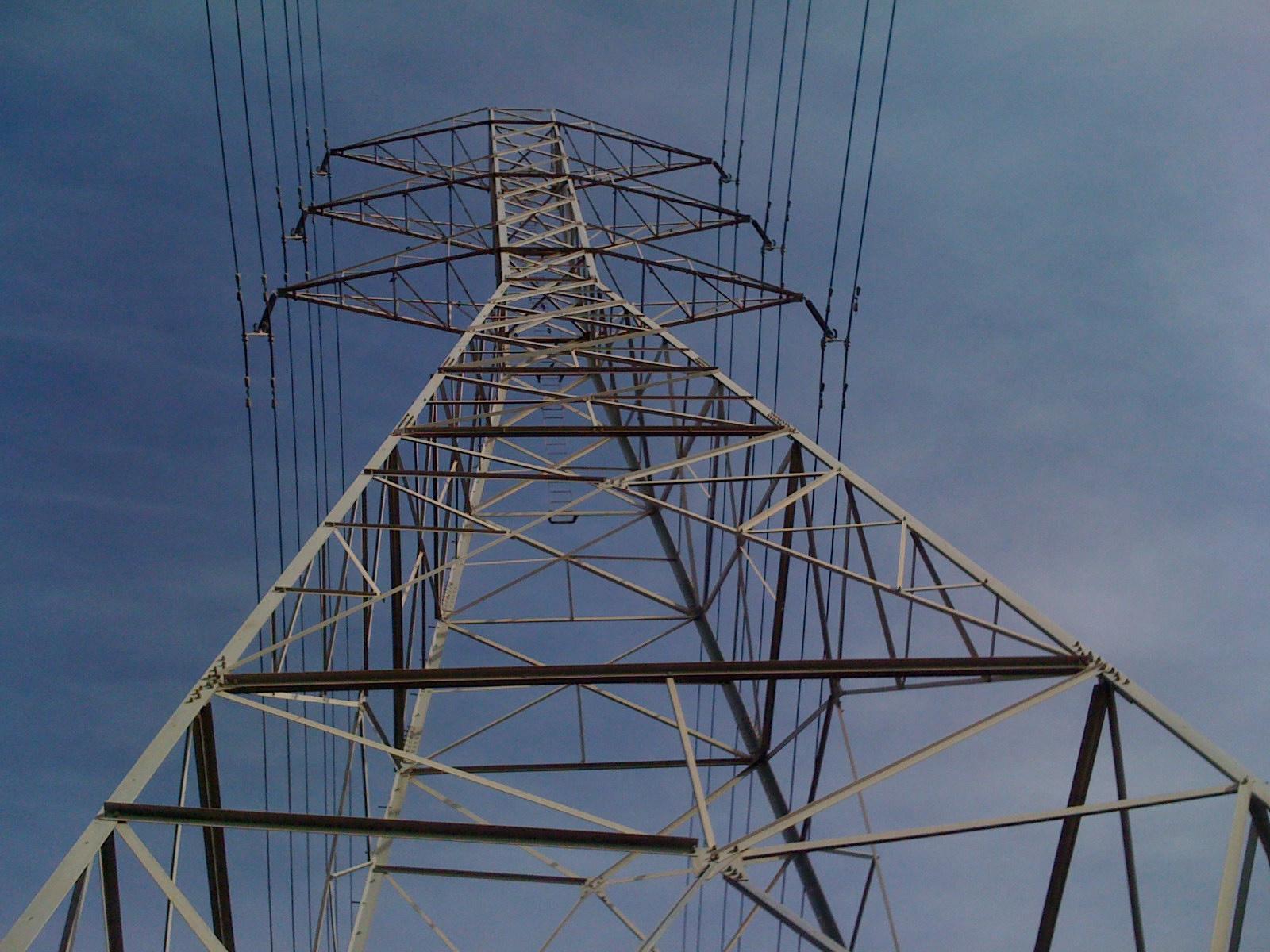 a power pole with wires running over it