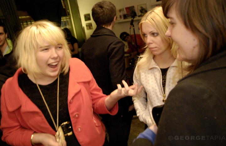 three women laughing and talking in the room