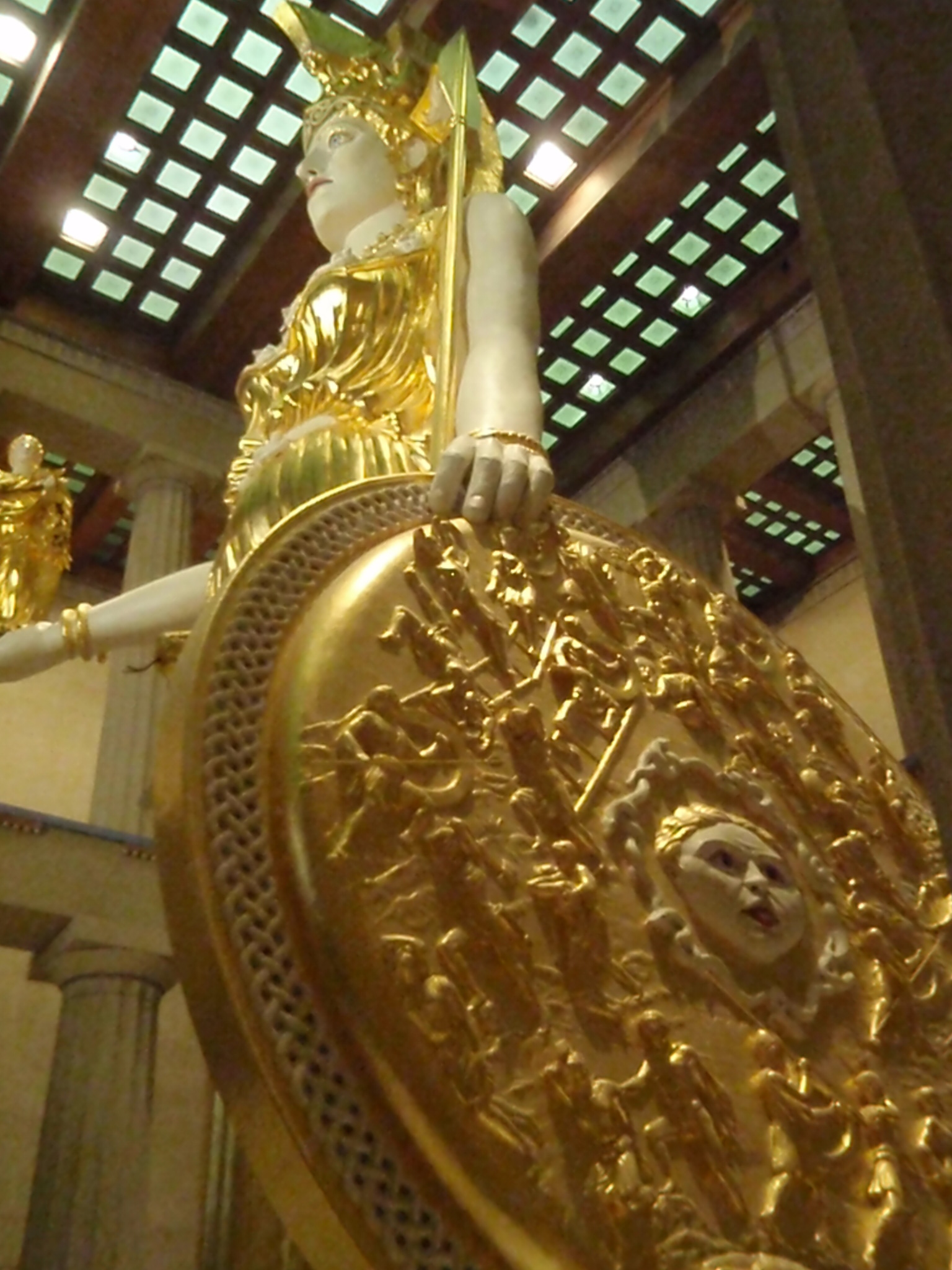 a large statue that has a very large gold face on it