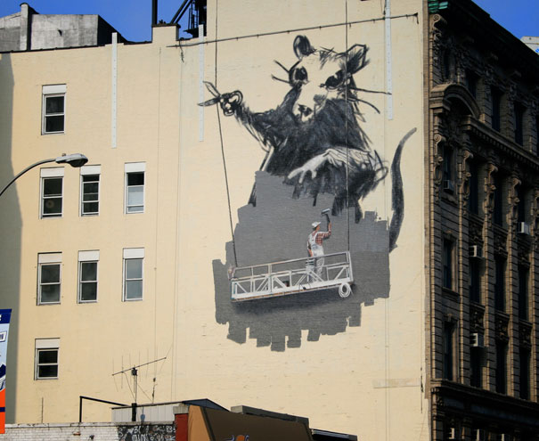 a large painting of a cat is shown on the side of a building