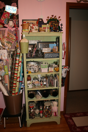 a green shelf filled with craft supplies and other items