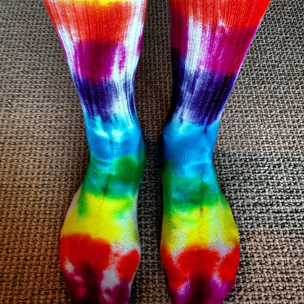 a person with colorful socks that have tie - dyed toes