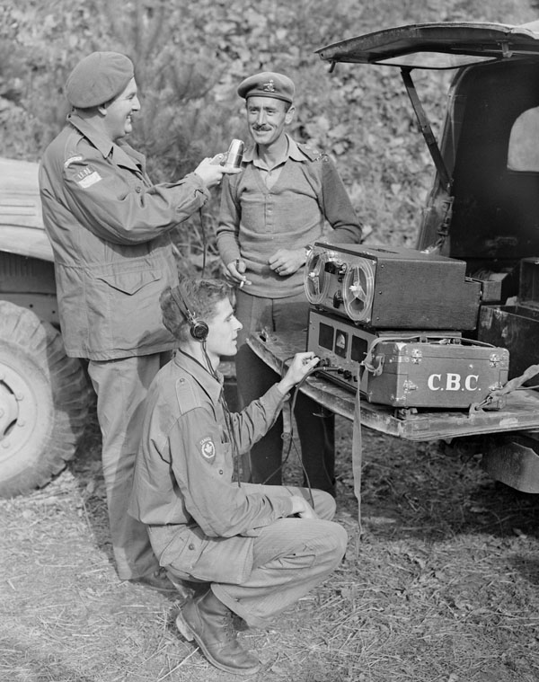 a group of military men are near a man with a radio