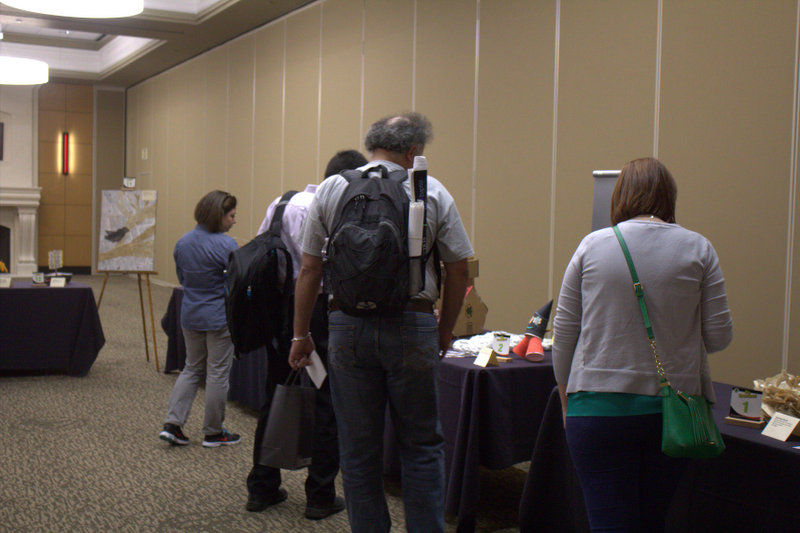 many people are gathered to get information from the information desk