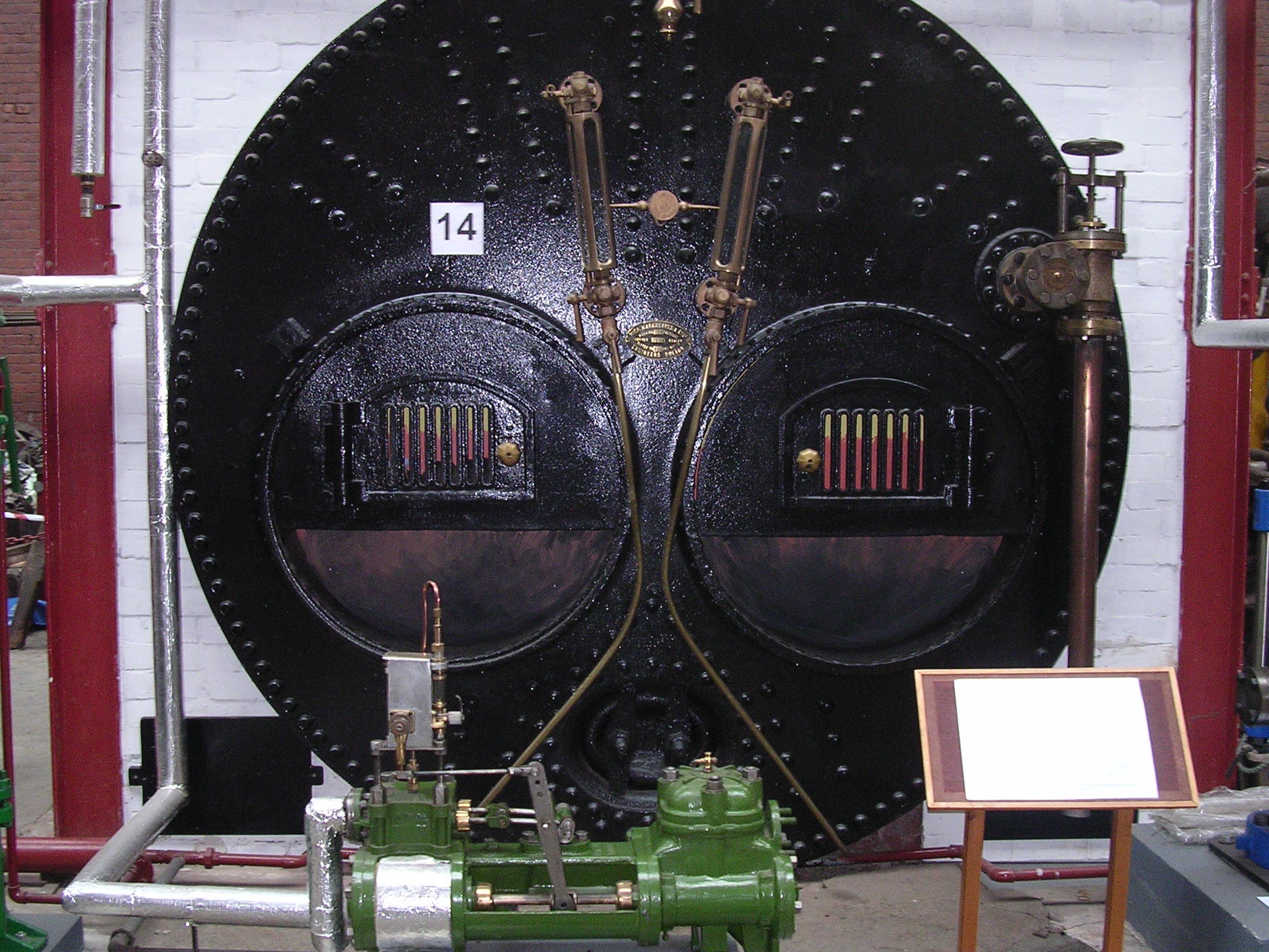 two machined wheels are on display in a building