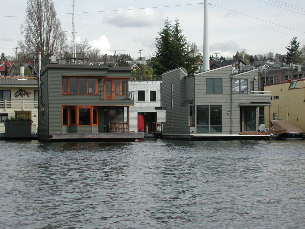 a house sitting on top of water next to a dock