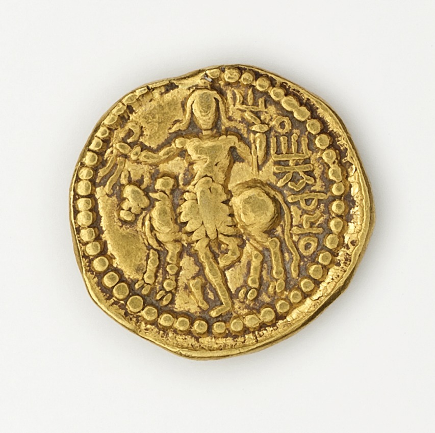 an ancient gold coin with two people riding on a horse