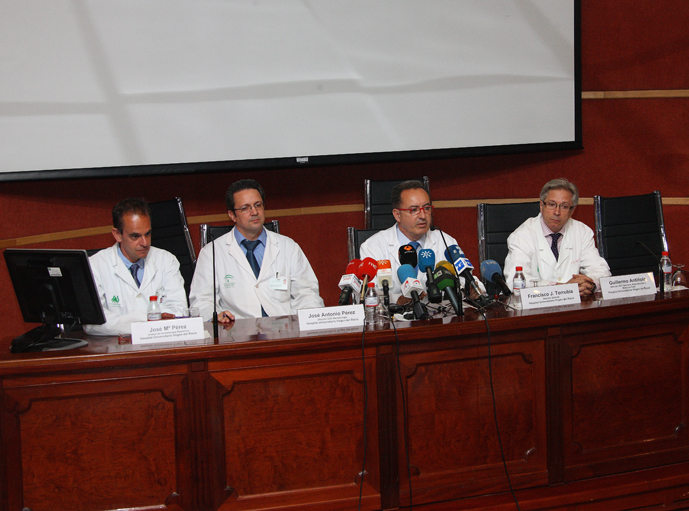 a group of doctors at a conference with microphones