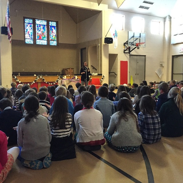 several people are sitting and facing an open room