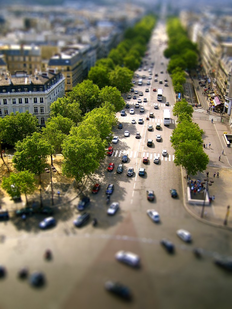 an overhead view of a busy street, with cars driving