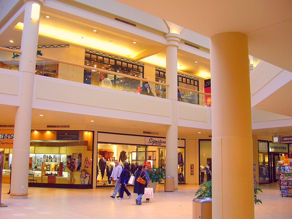 a mall has people walking around inside it