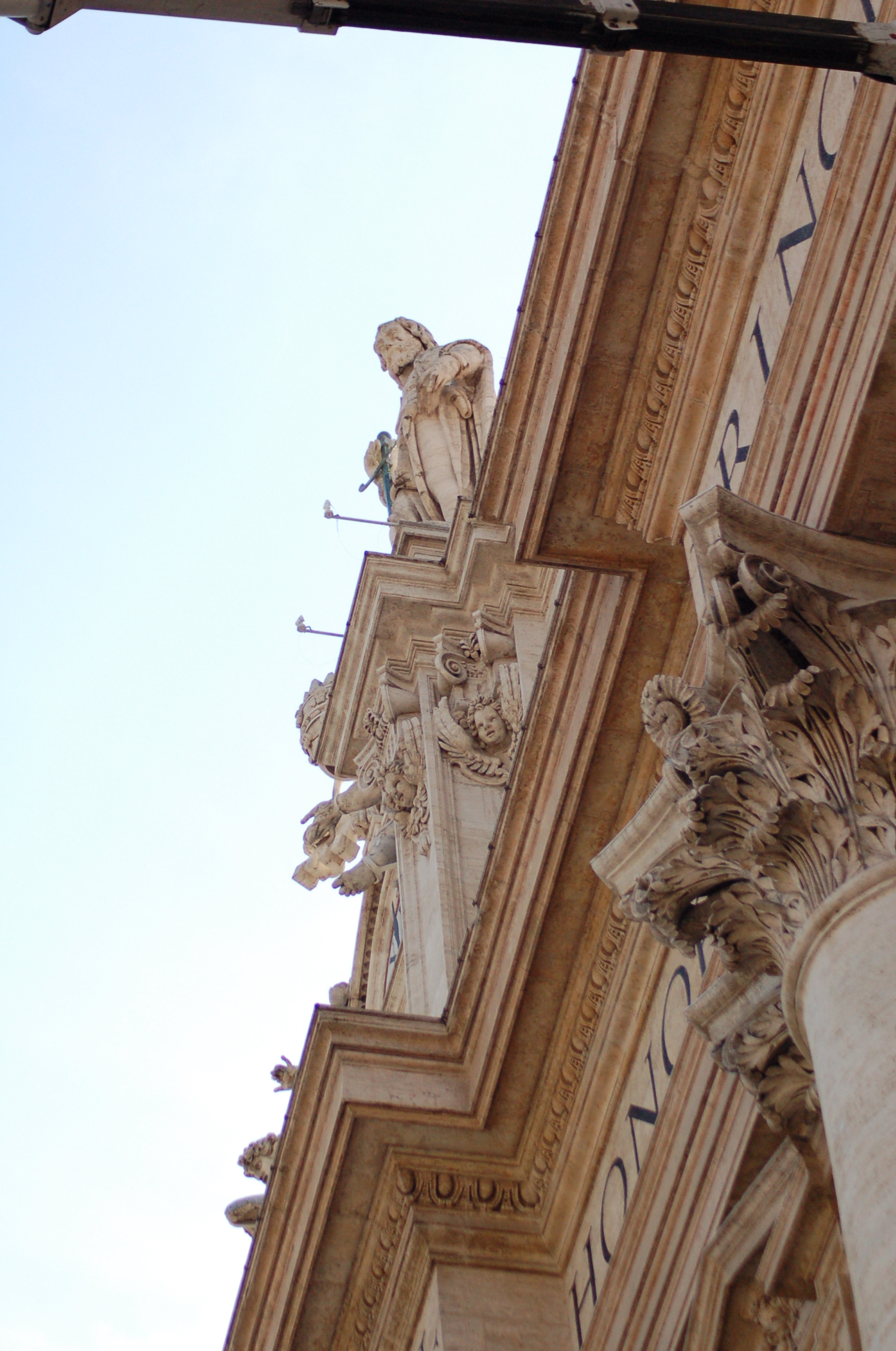 a tall brown building has sculptures on the side of it