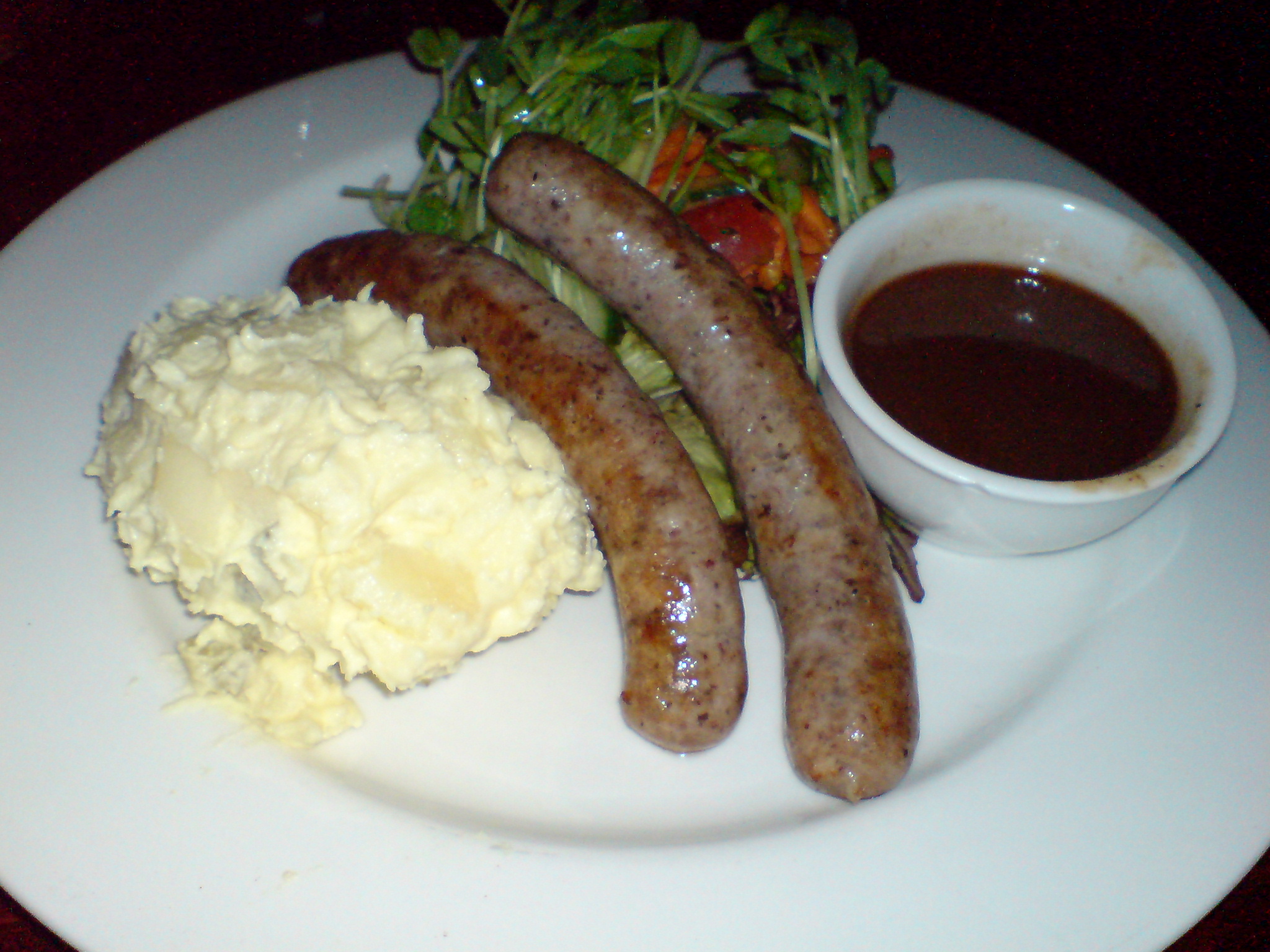a plate with mashed potatoes and some sausages