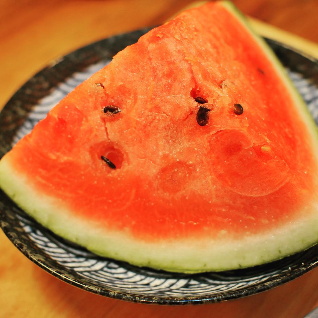 a watermelon on a blue and white plate