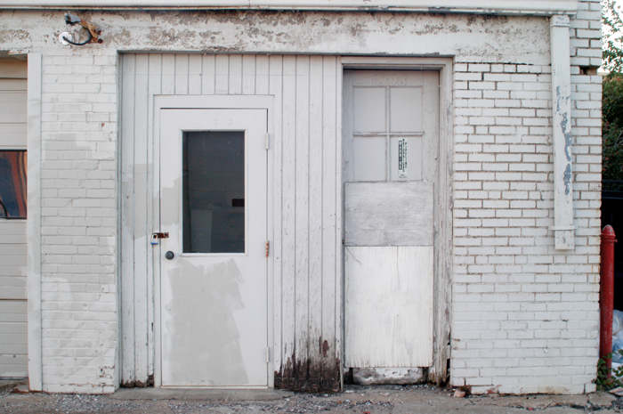 a dirty white door and some windows